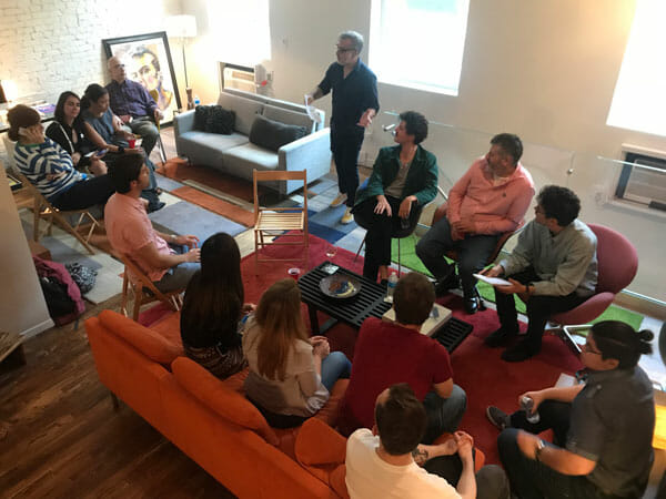 Professor David Gerstner presents to students during a recent evening reception with the French director, Christophe Honore (seated second from Gerstner's left).